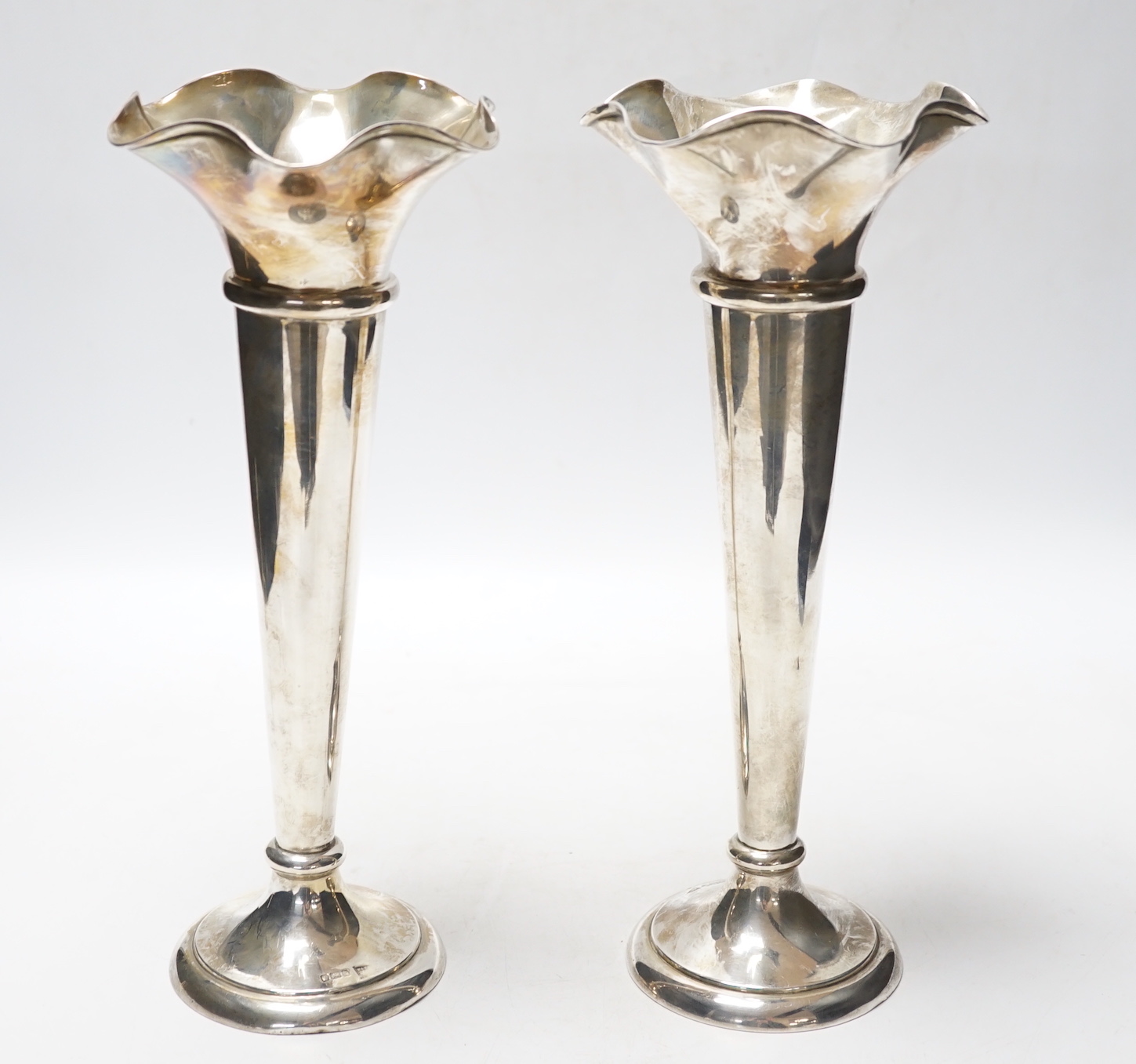 A pair of George V silver spill vases, with wavy rims, Walker & Hall, Sheffield, 1911, 27.1cm, weighted.